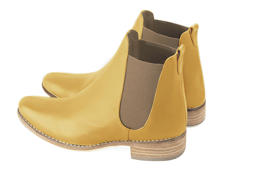 Mustard yellow and taupe brown women's ankle boots, with elastics. Round toe. Flat leather soles. Rear view - Florence KOOIJMAN